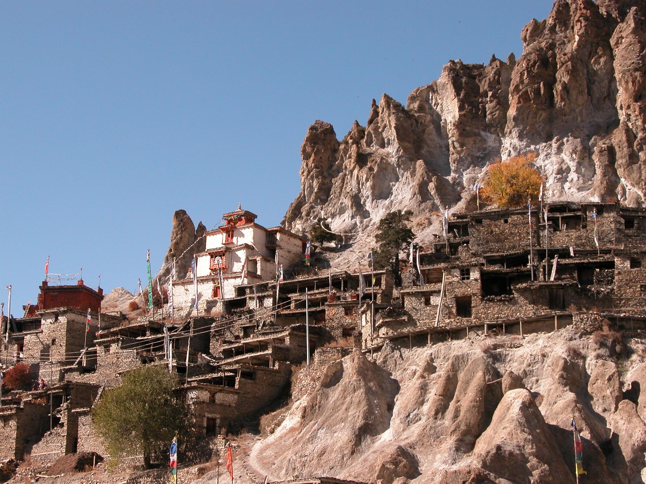 Annapurna 12 10 Braga Braga (3500m) is a Tibetan-style village of about 200 houses hiding behind a photogenic steep, eroded rock outcrop. The houses are stacked one atop the other, each with an open veranda formed by a neighbours rooftop. The gompa is perched on a high crag overlooking the village, and is estimated to be 400 to 500 years old. The gompa comprises three main buildings and belongs to the Kagyu sect of Tibetan Buddhism.